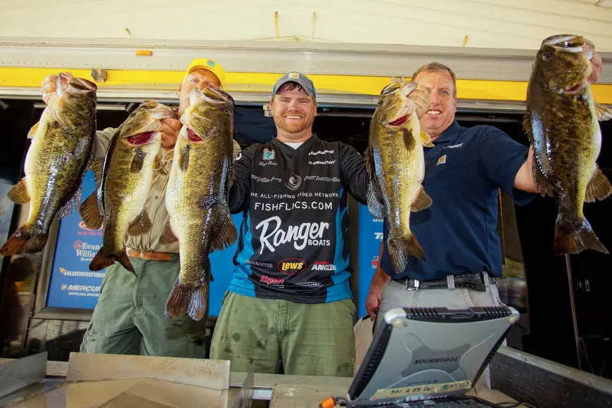 fisherman with five large bass at weigh-in