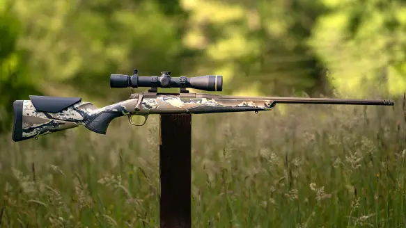 The new Browning X Bolt 2 Speed OVIX MB bolt-action rifle on a post with woods in background.