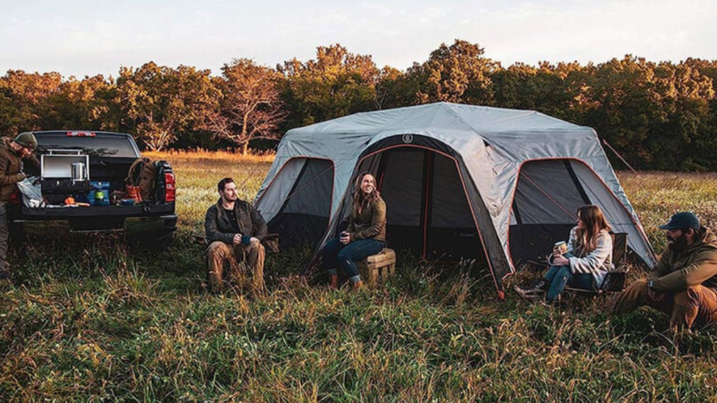 Campers hanging out outside Bushnell cabin tent