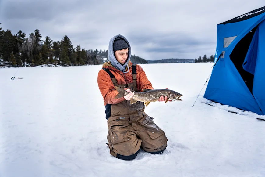 An angler poses with a lake trout caught in the Boundary Waters of northern Minnesota.