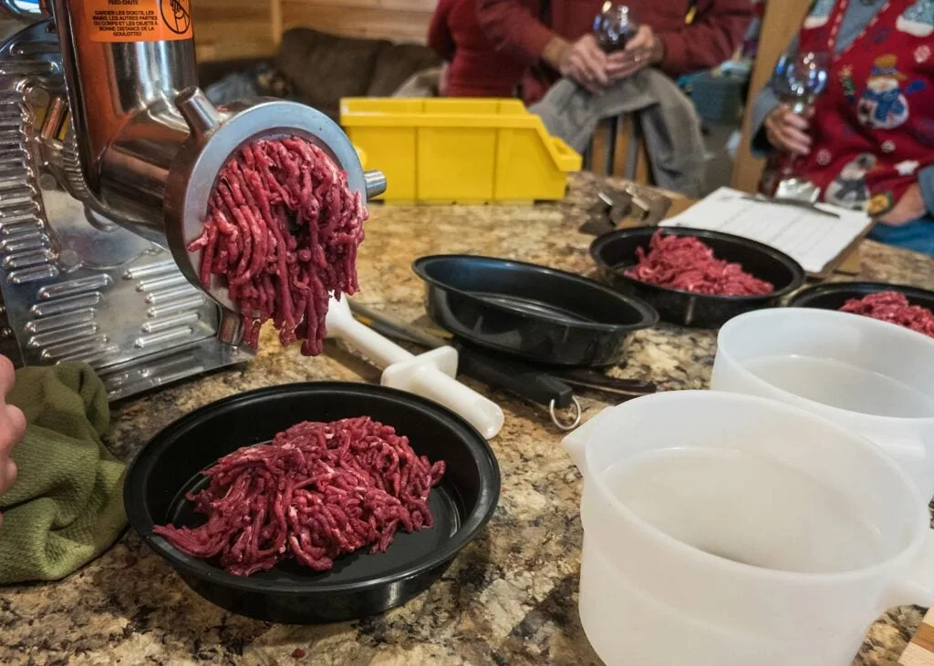 A meat grinder and ground venison.