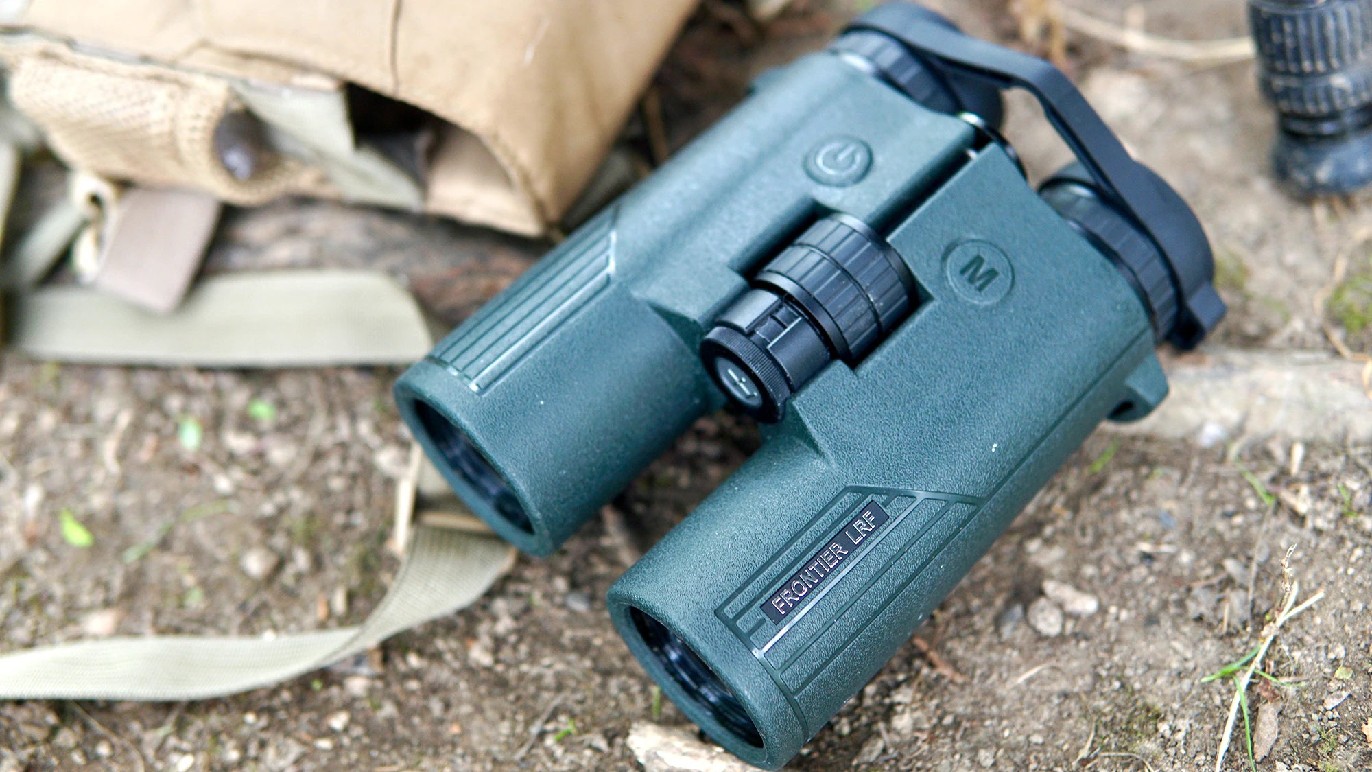 Hawke Frontier LRF rangefinding binocular lying on the ground with a bino harness.