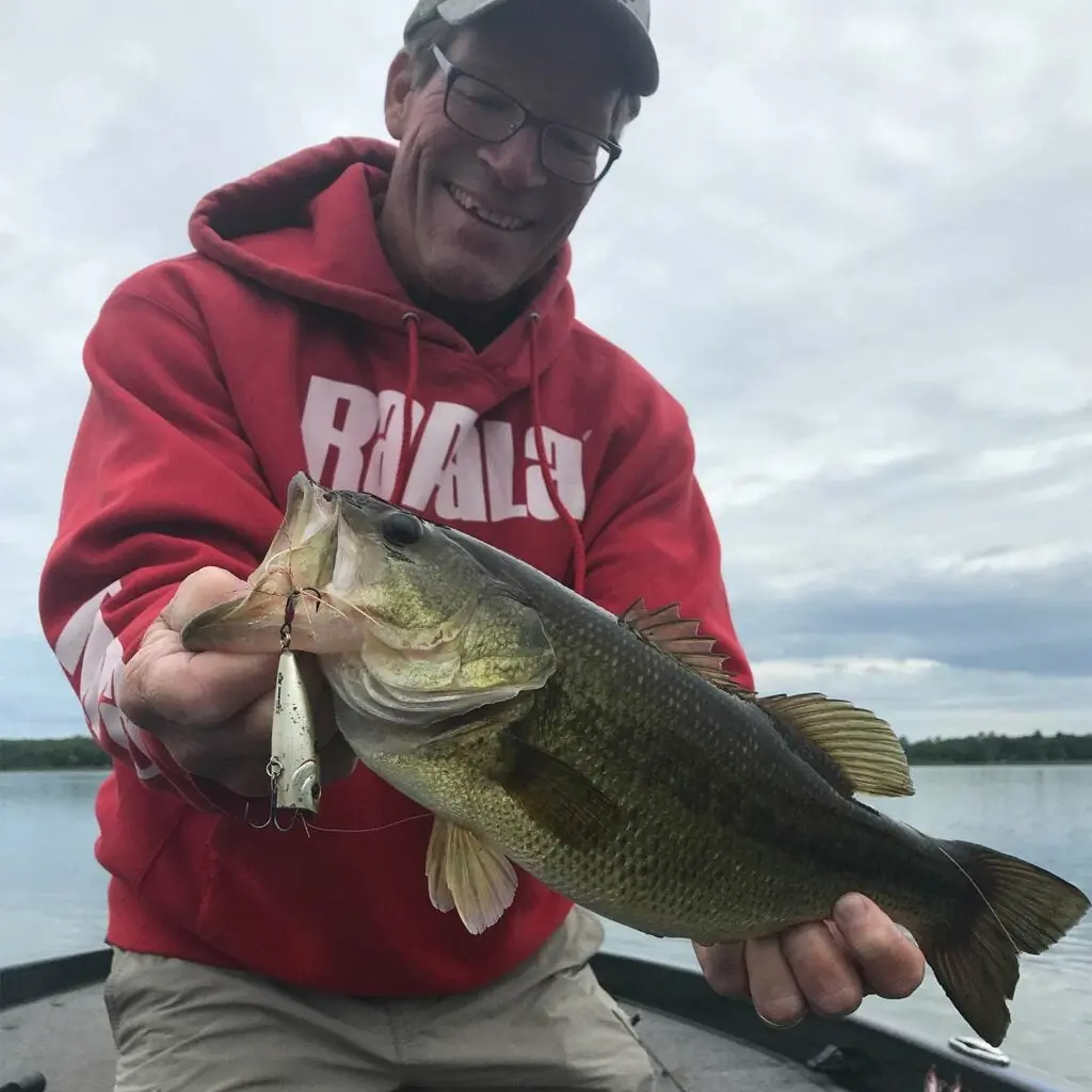 Steve Quinn holding up a largemouth bass.