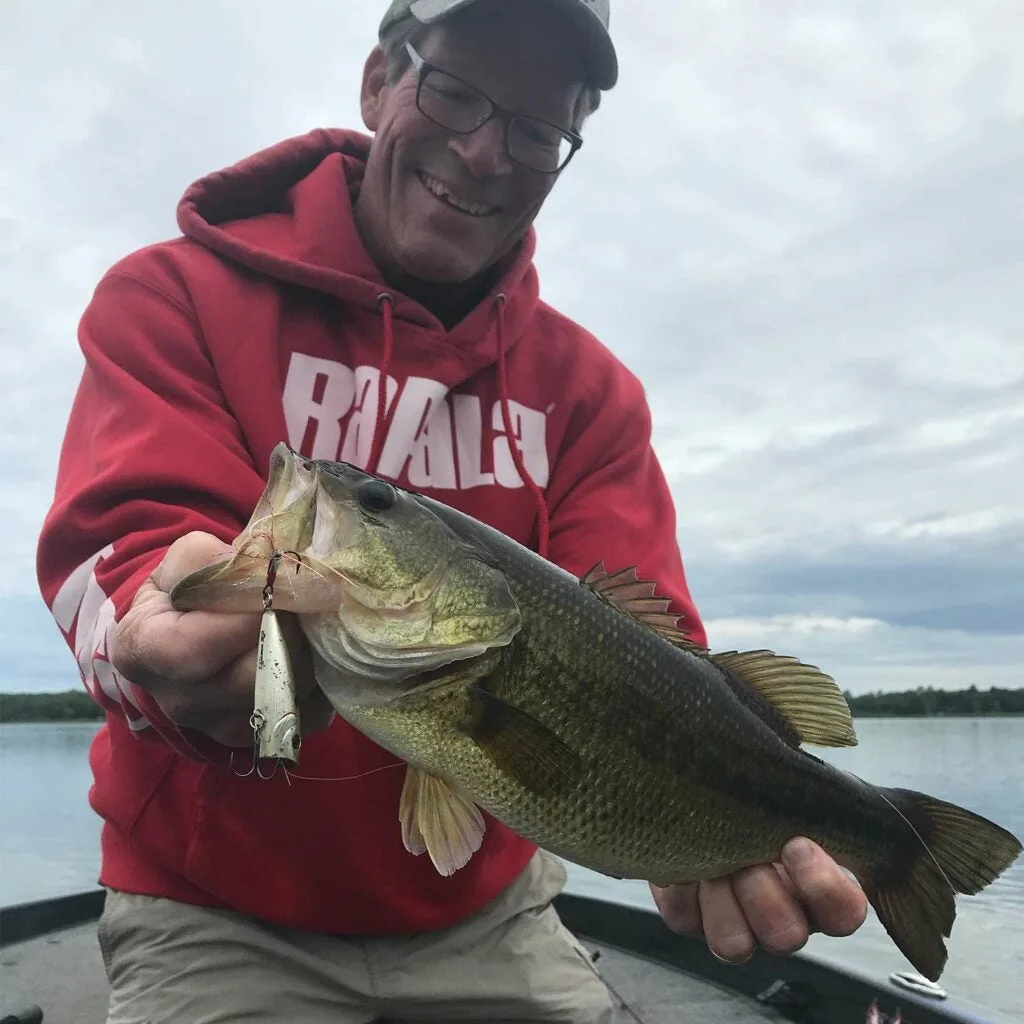 Steve Quinn holding up a largemouth bass.