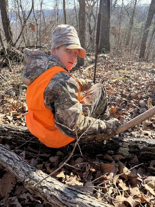 Hunter Windsor sits on a log after shooting a trophy buck in Ohio. 