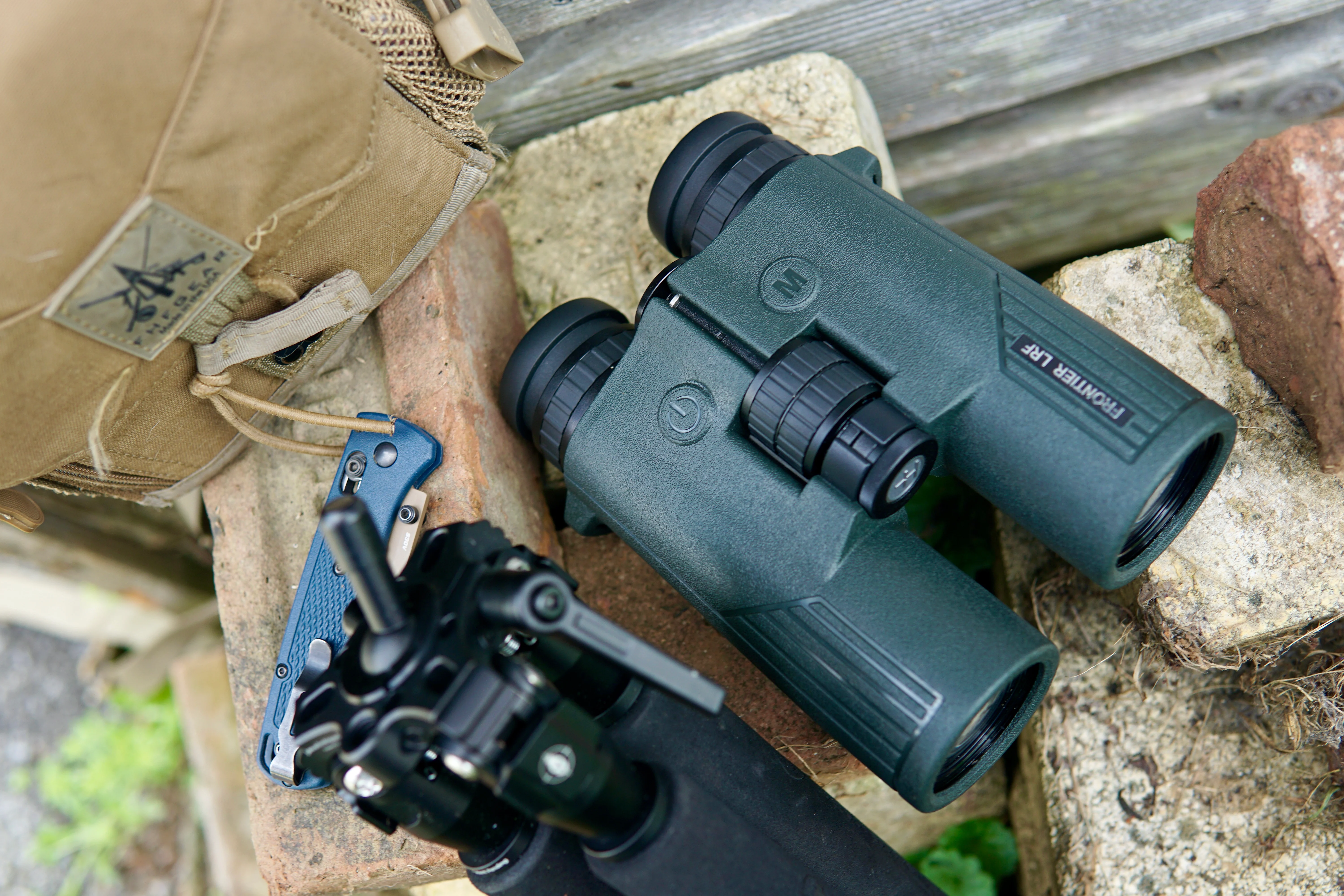 Hawke Frontier LRF rangefinding binocular sitting on bricks with tripod and bino harness. 