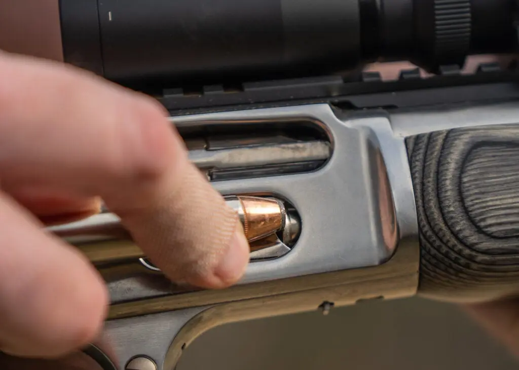 Hand loading cartridges into a Marlin 1895.