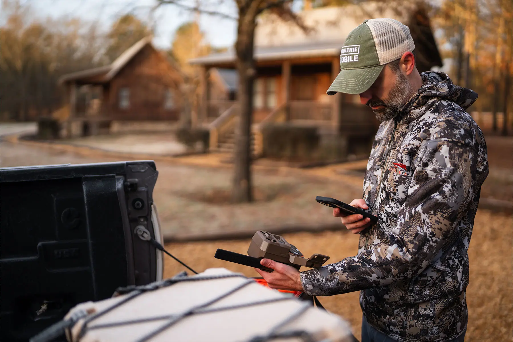 A hunter checks his cellular trail camera. 