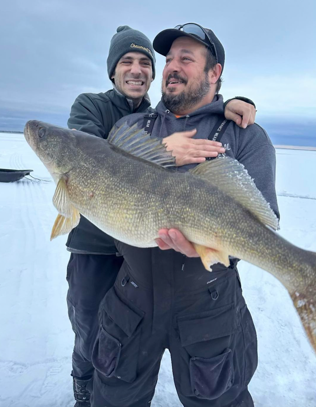 An ice fisherman poses with a trophy walleye caught in Upstate New York. 