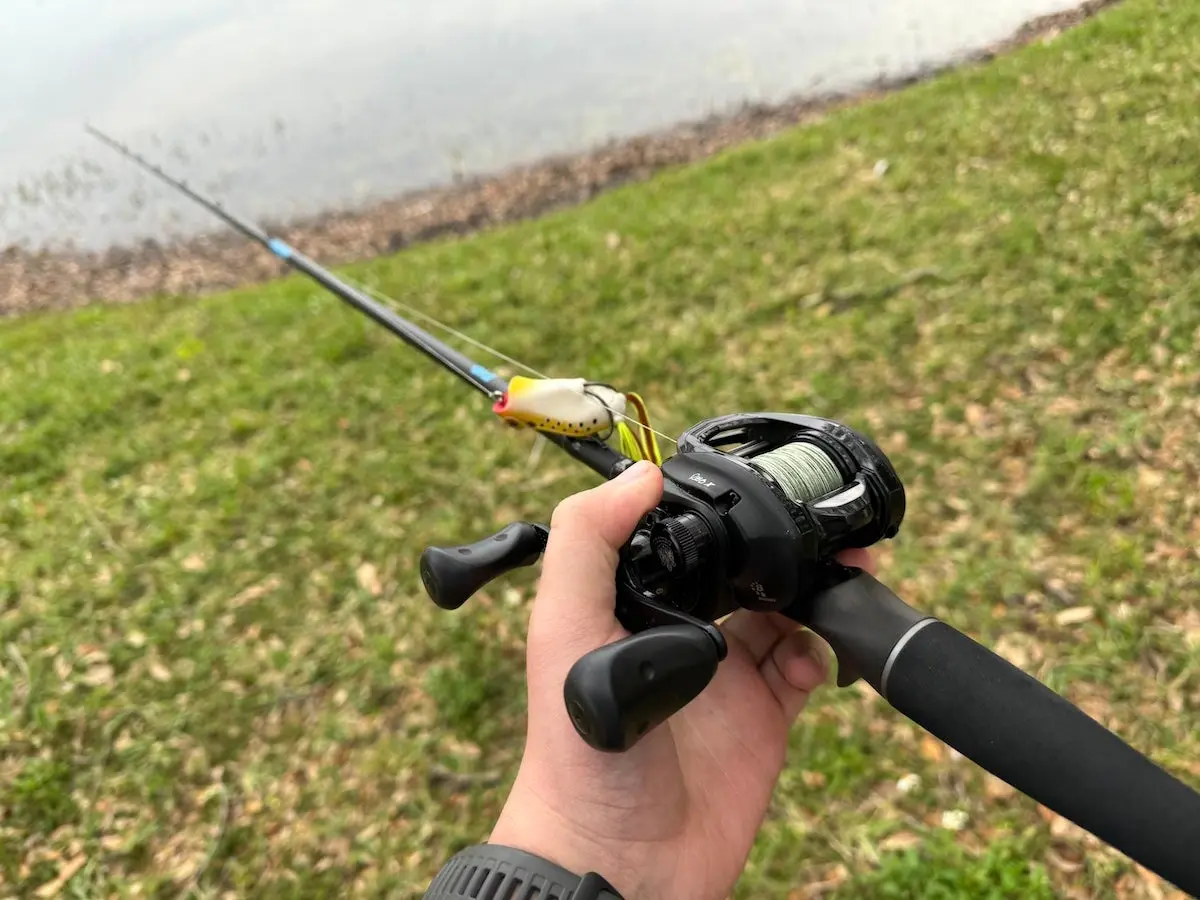 Angler holding H2OX Evo Series Casting Rod