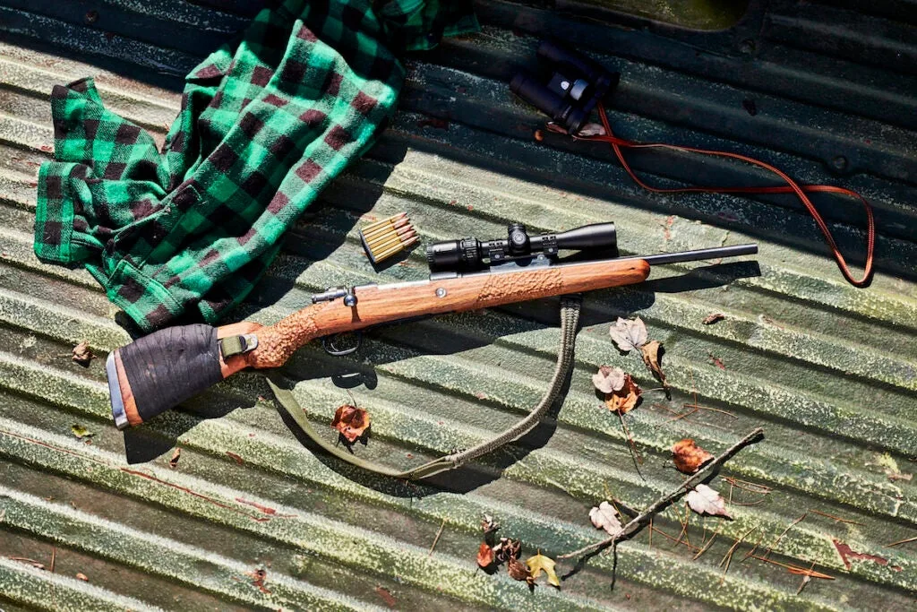 Scout rifle in the bed of a pickup truck.