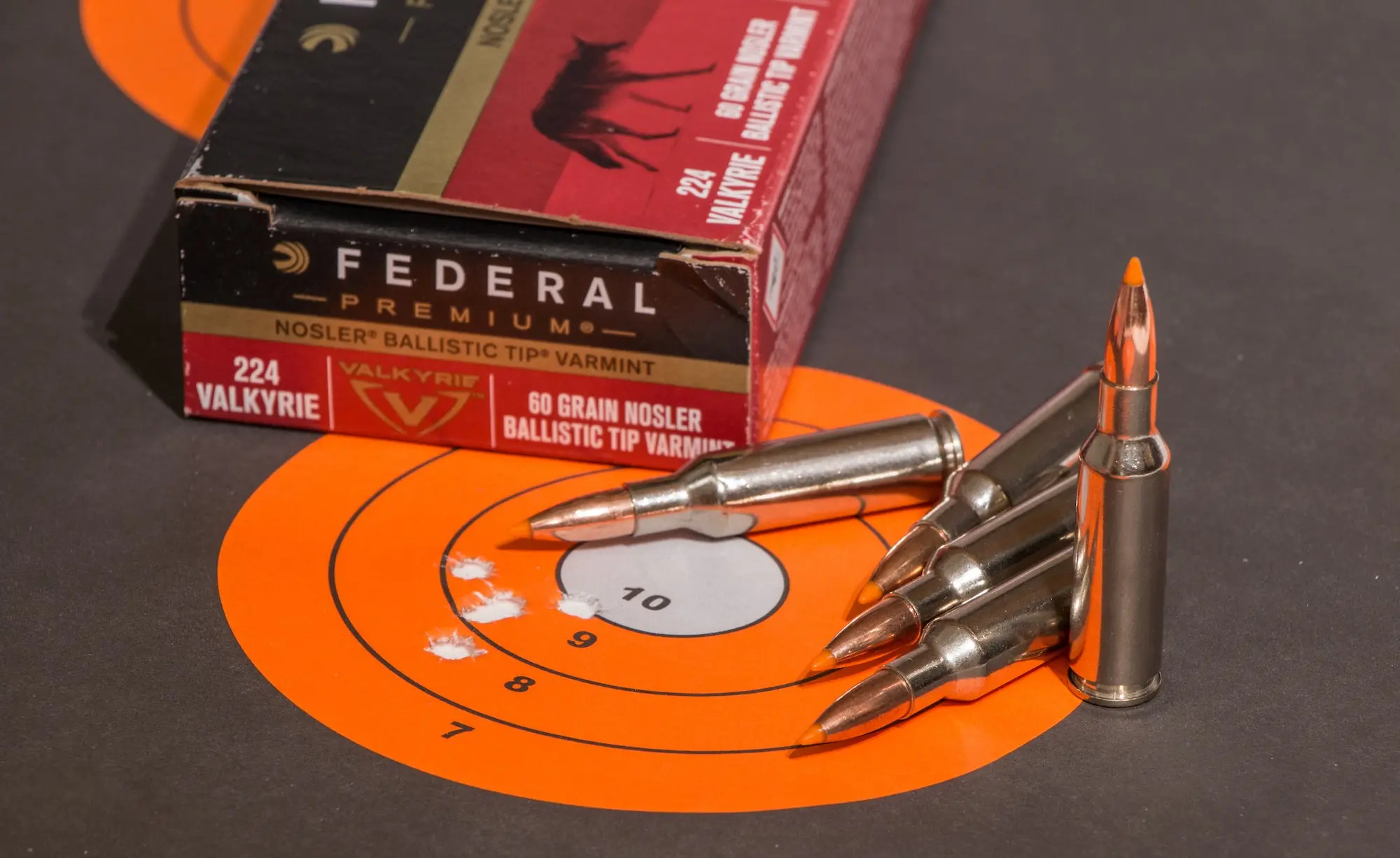 224 Valkyrie vs 223: Target with bullet holes and box of ammunition.