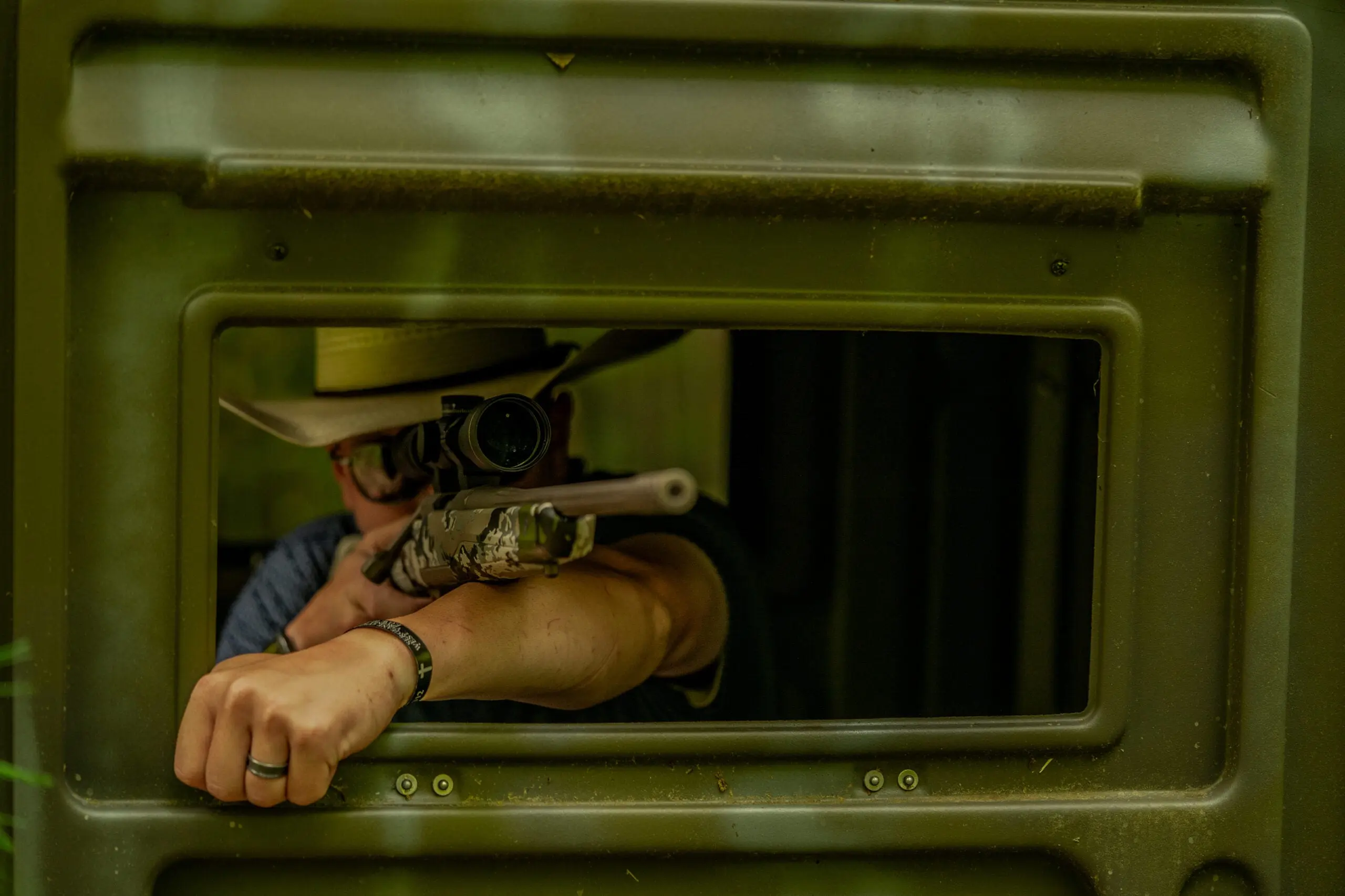 a test-panel member shoots the Browning rifle from a box blind