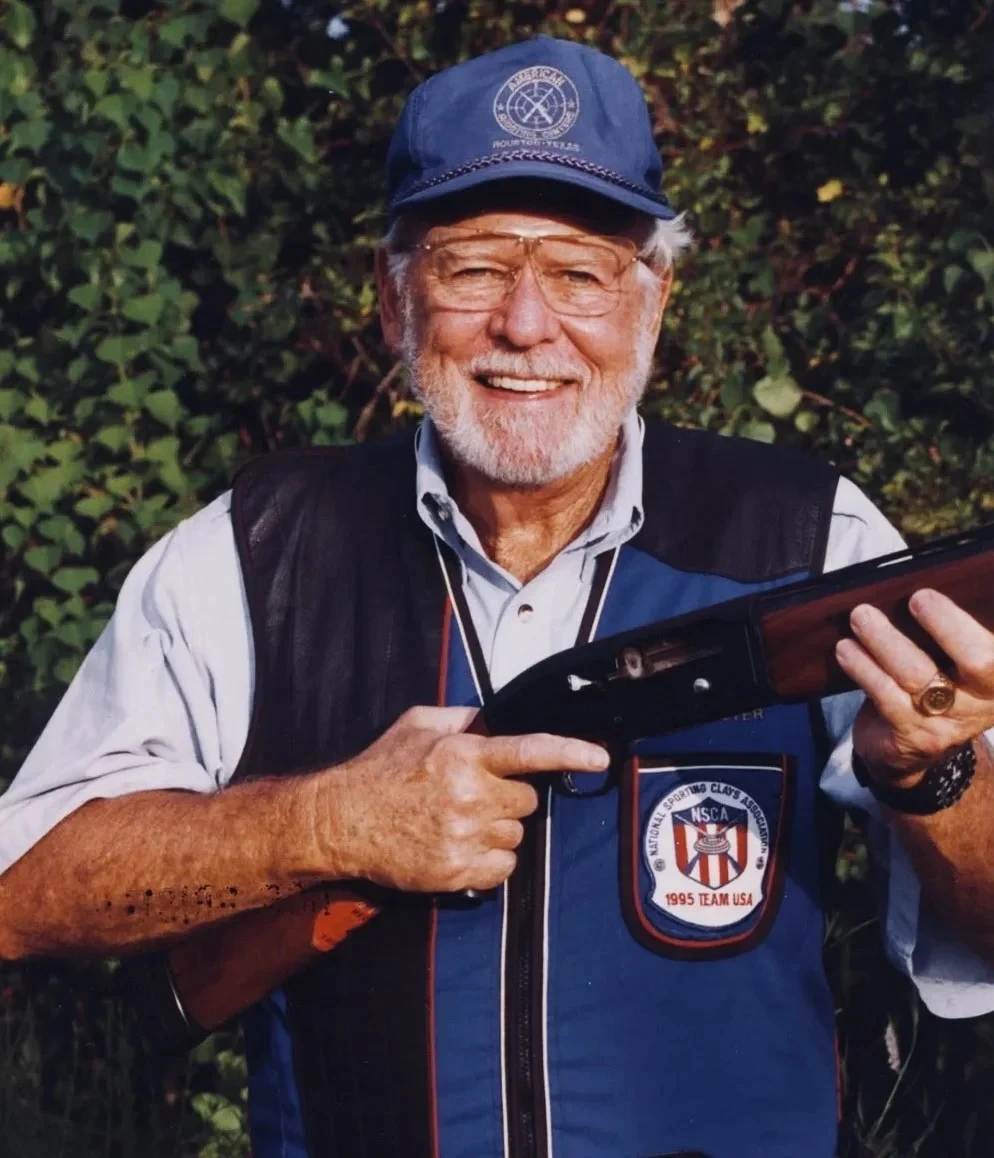 Image of Bob Brister holding a shotgun