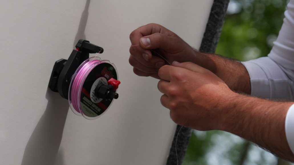 Man using Rapala Smart Hub Fishing Line Spooler