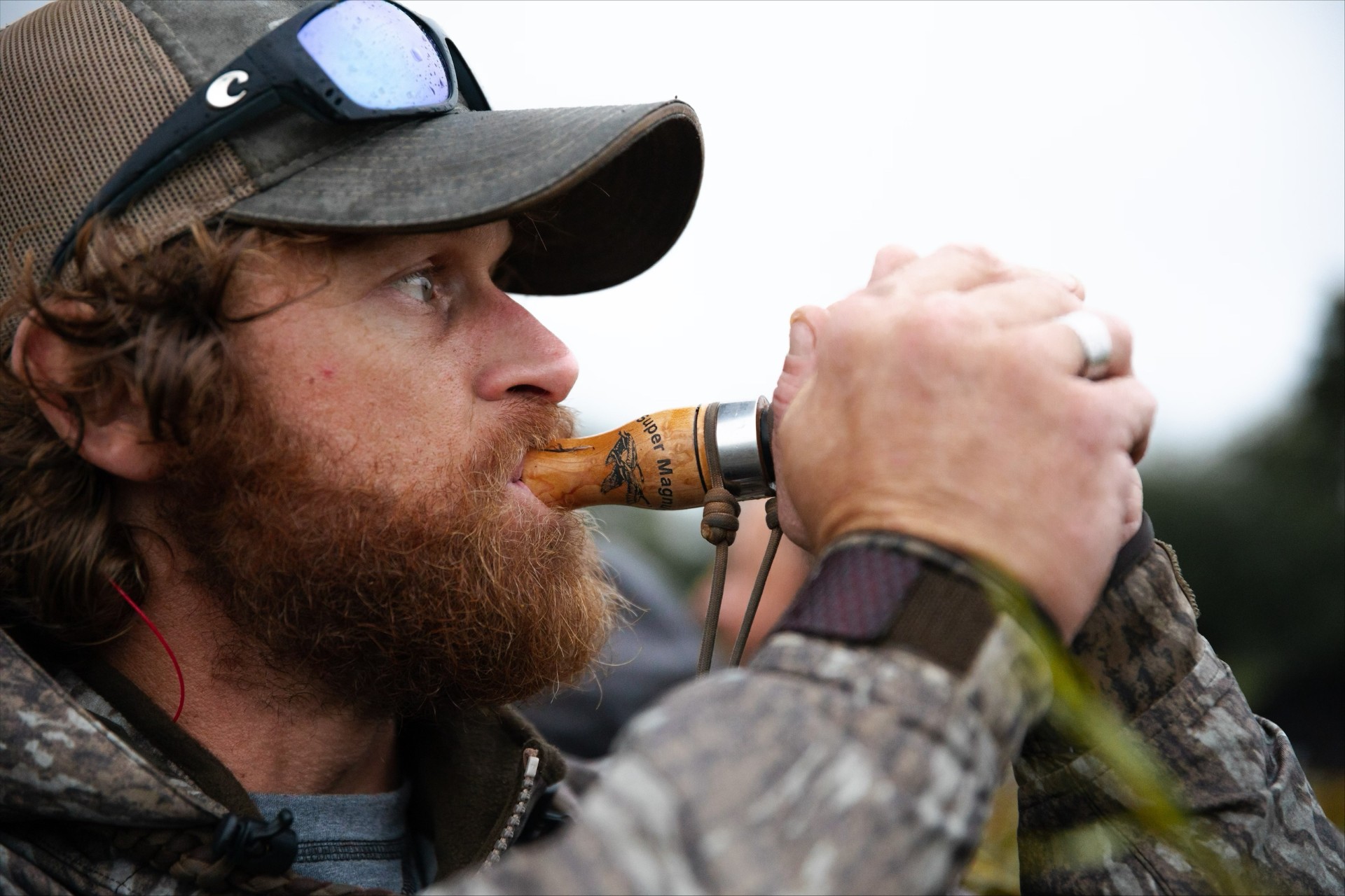 Hunter blowing goose call 