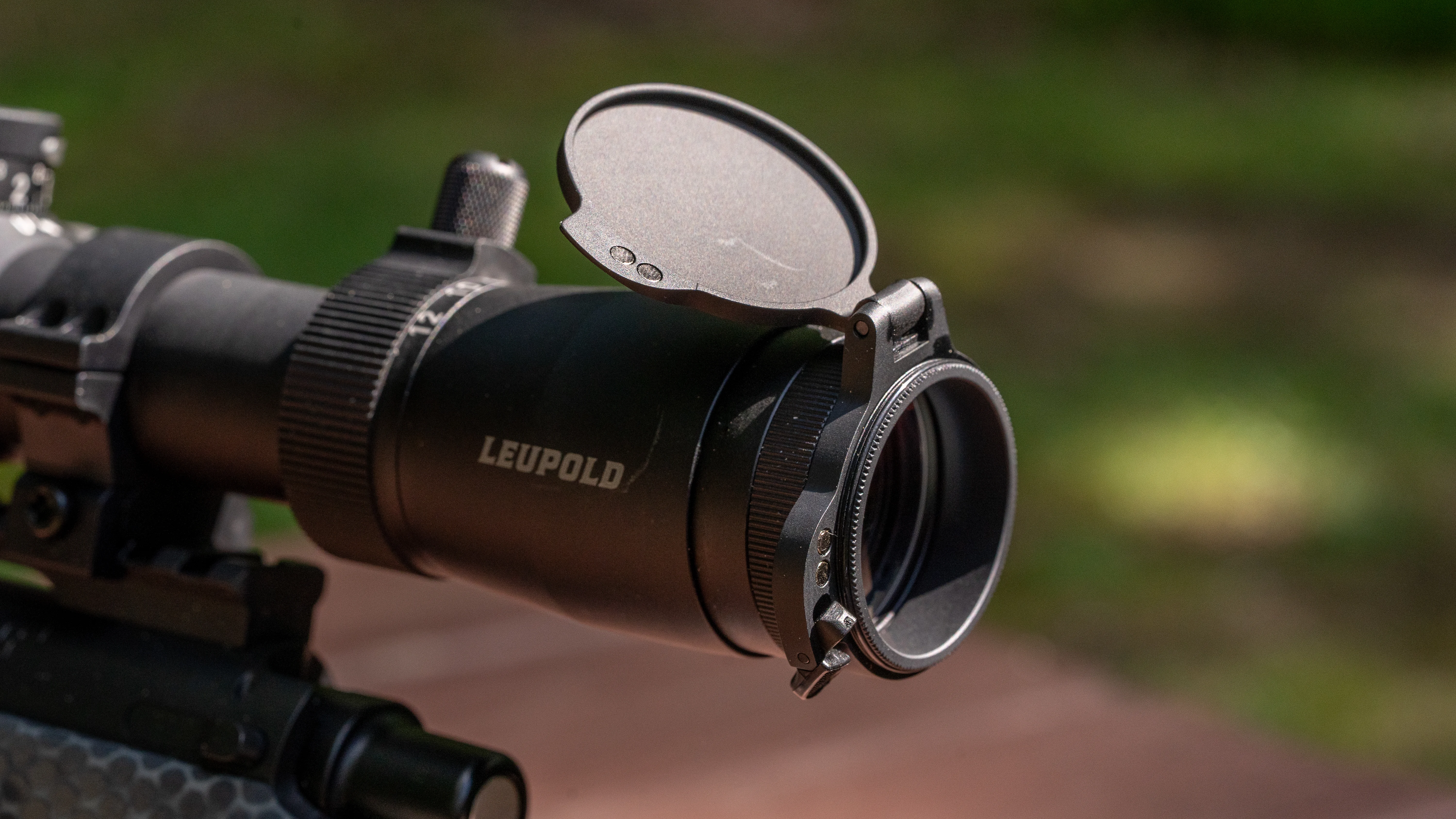 A closeup photo of Alumina Flip-Back lens caps of a Leupold VX-6HD Gen 2 rifle scope.