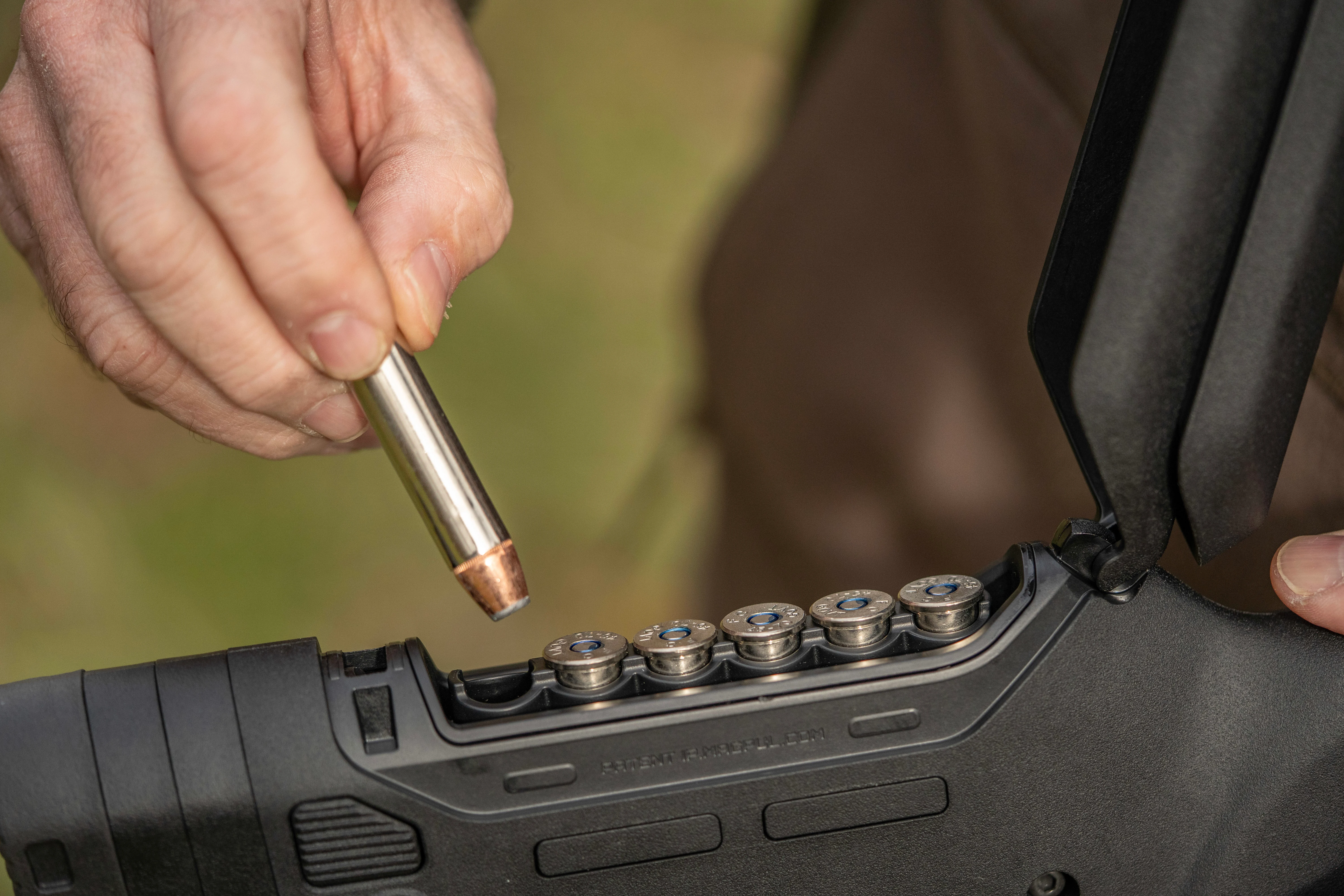 A shooter stores rifle cartridge in a storage compartment in a rifle's butt stock. 