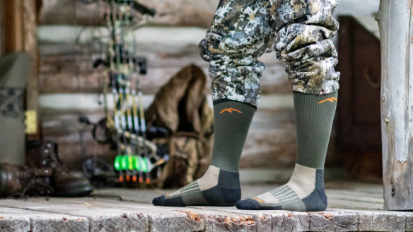 Hunter wearing Darn Tough Hunting Socks on cabin porch