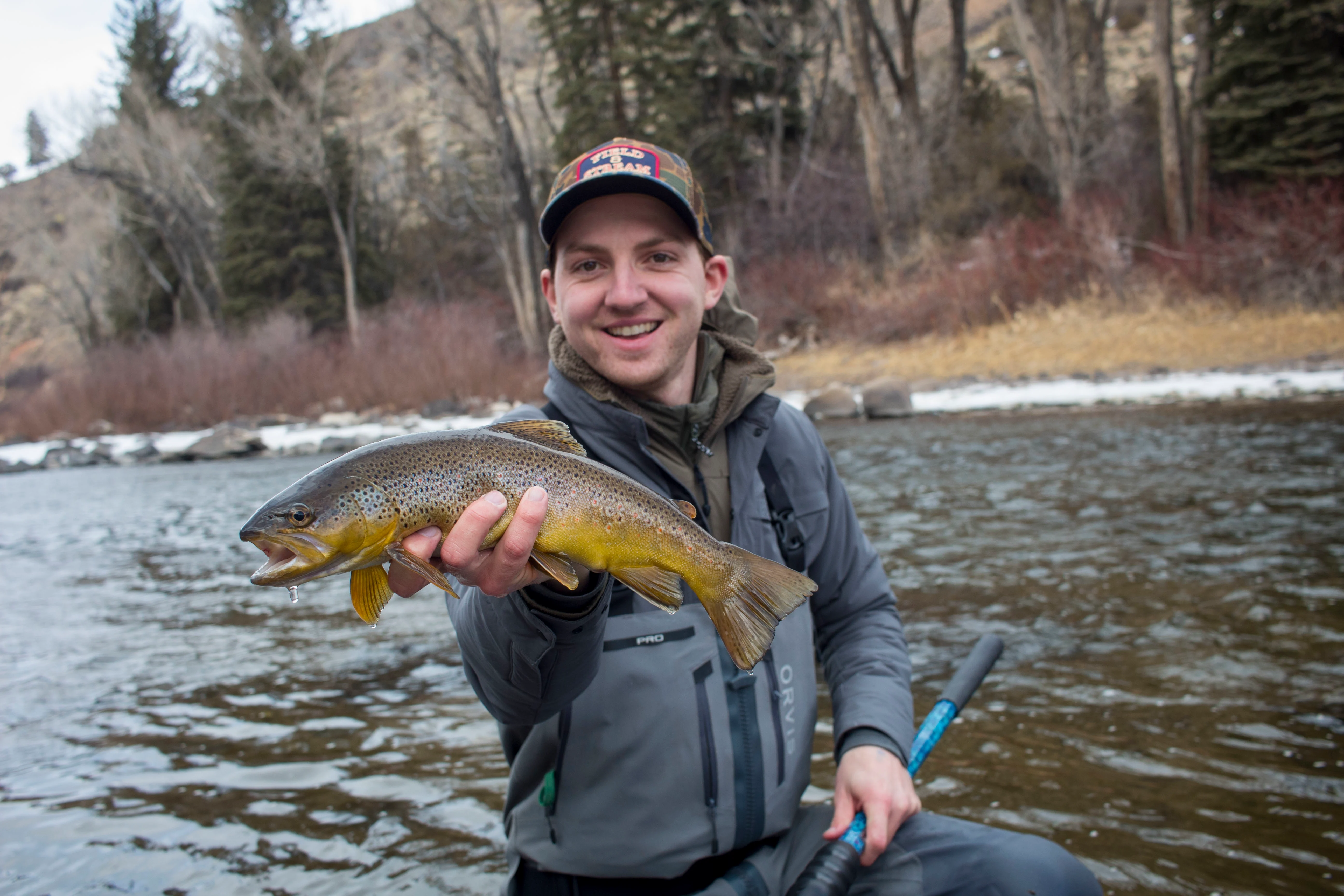 Angler holds up a wintertime brown trout