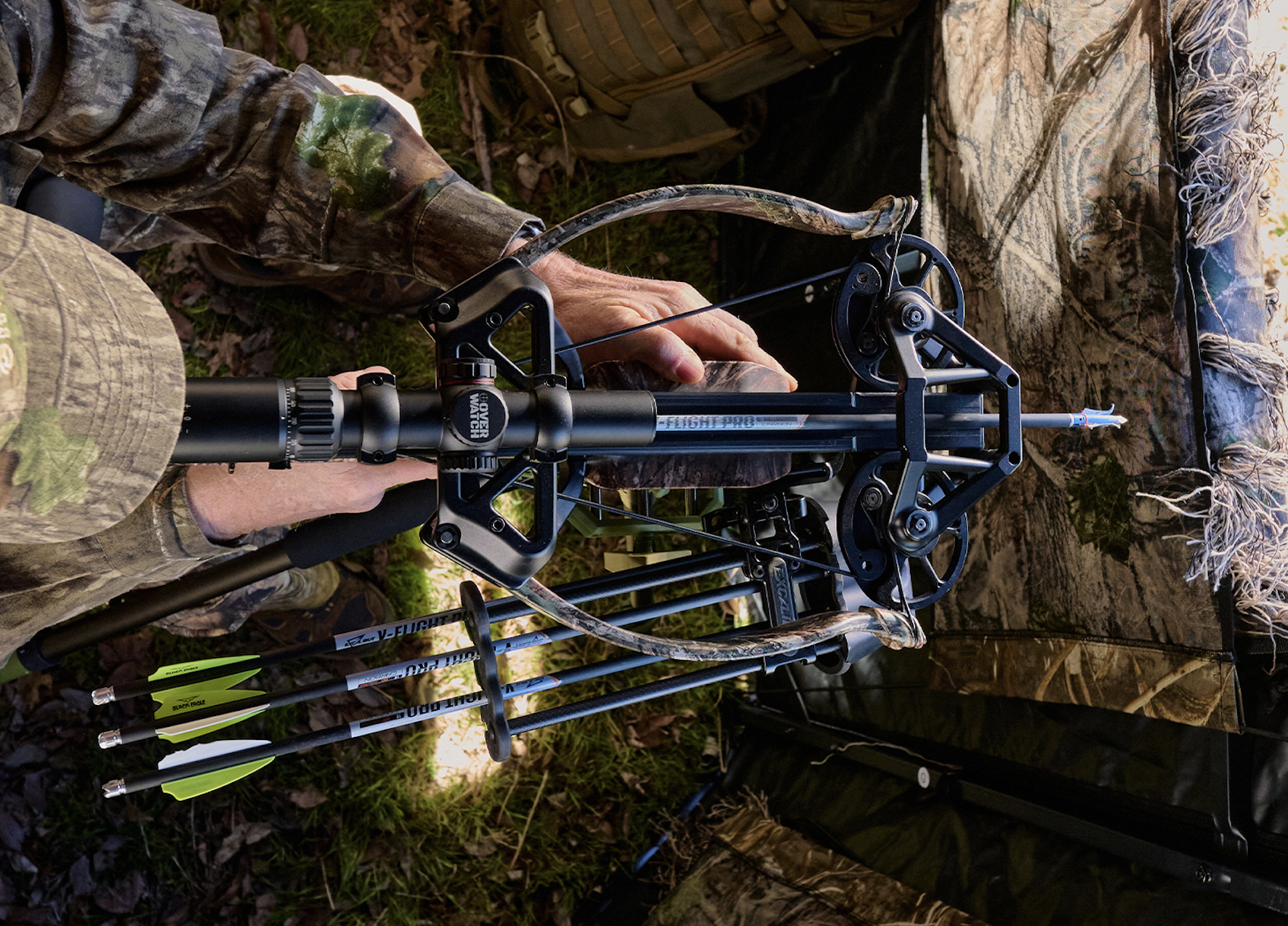 A hunter shoots the new Excalibur Hybrid X crossbow from a ground blind. 