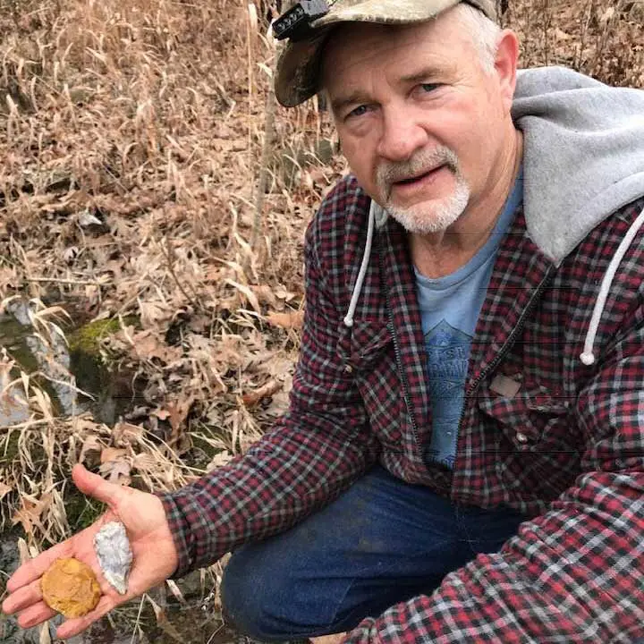 brad harris holding stone tools