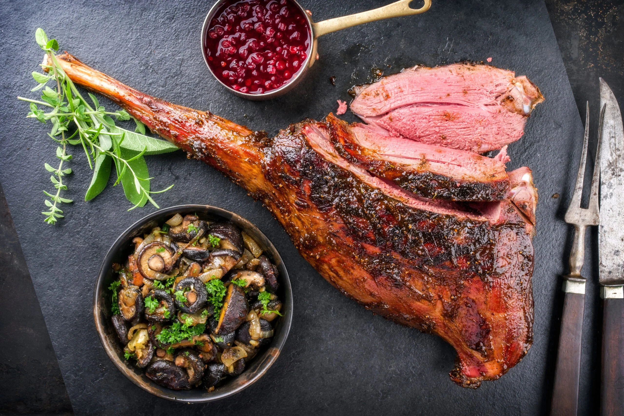 a haunch of venison with cranberry and mushrooms