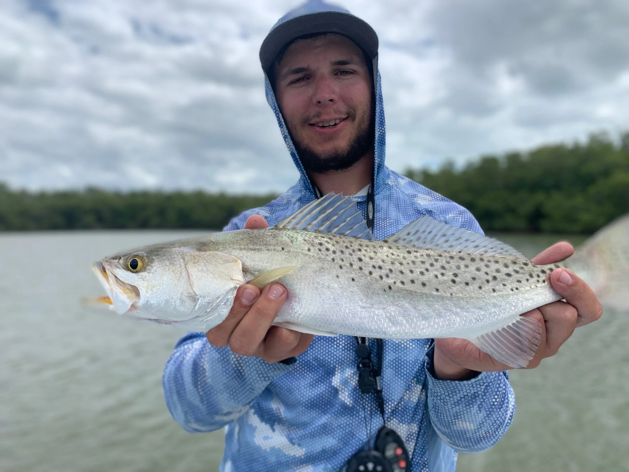 The author holds up a good-sized speckled sea trout.