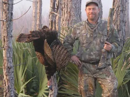 A hunter next to a large public land turkey.