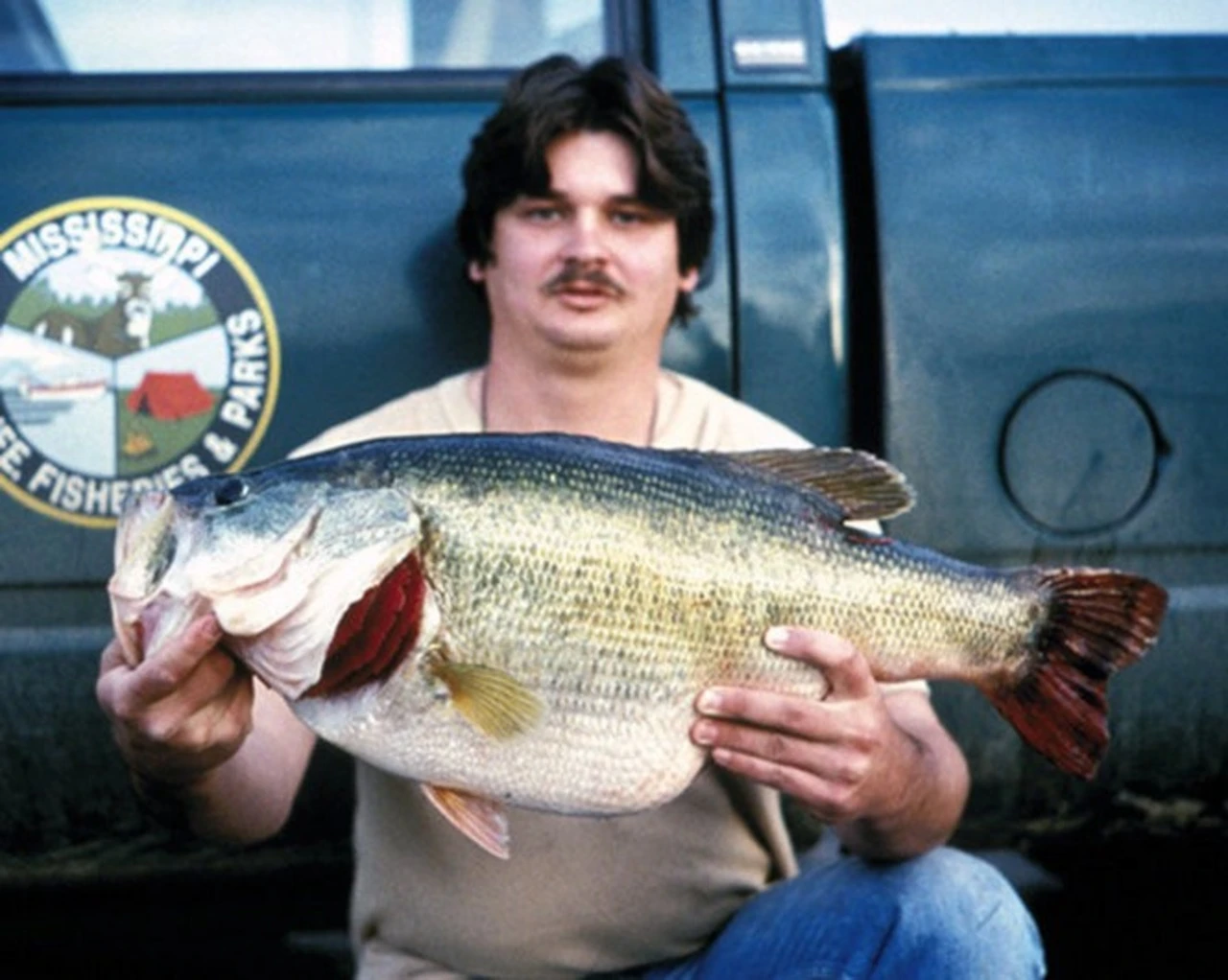 An angler poses with the Mississippi record for largemouth bass. 