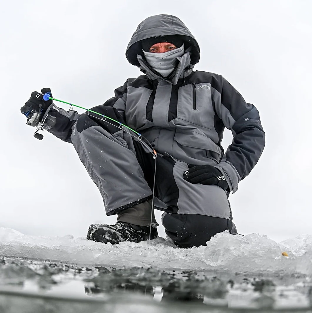 Angler wearing Aftco Hydonaut Insulated Bibs while ice fishing