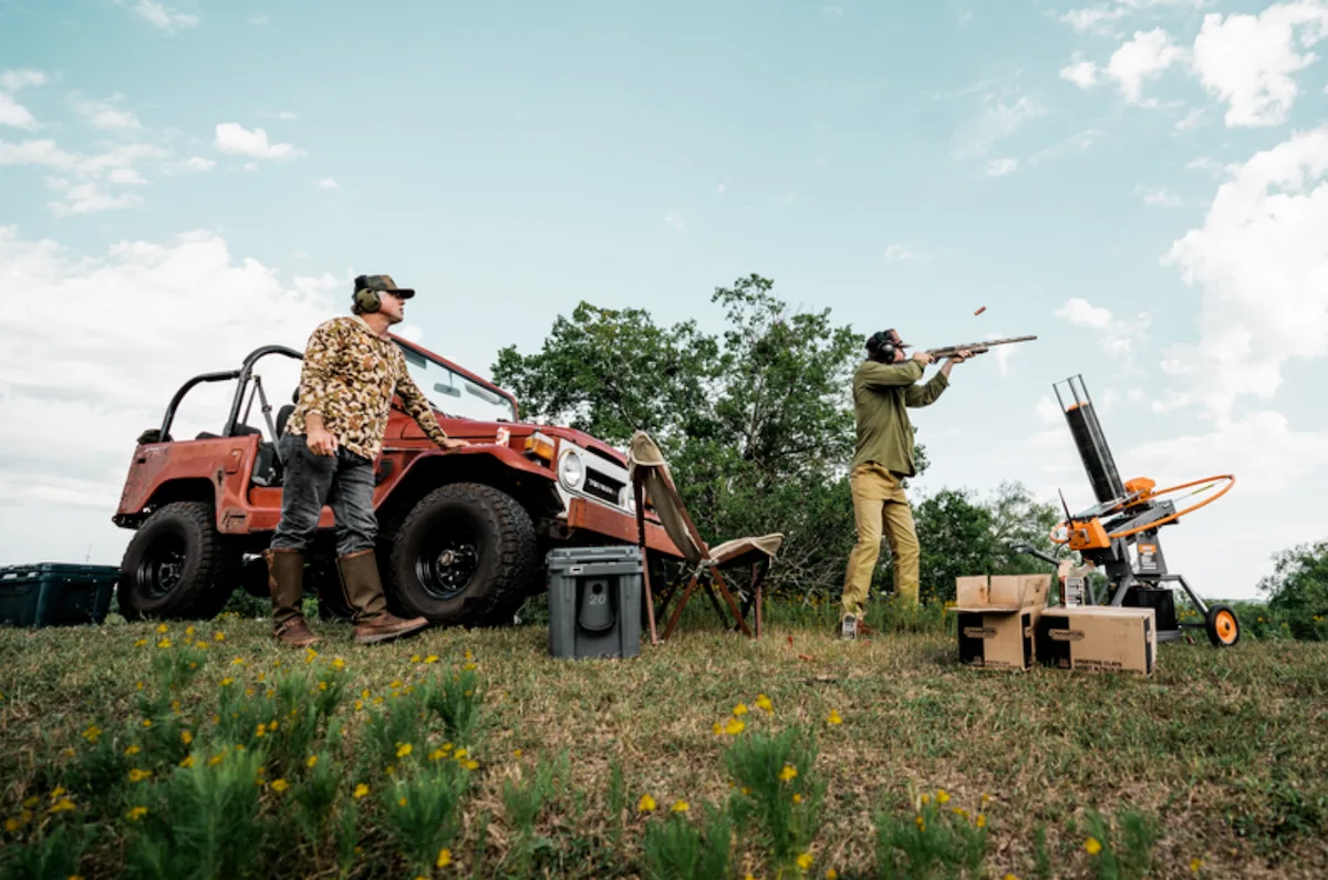 Two men shooting clays wearing Duck Camp apparel