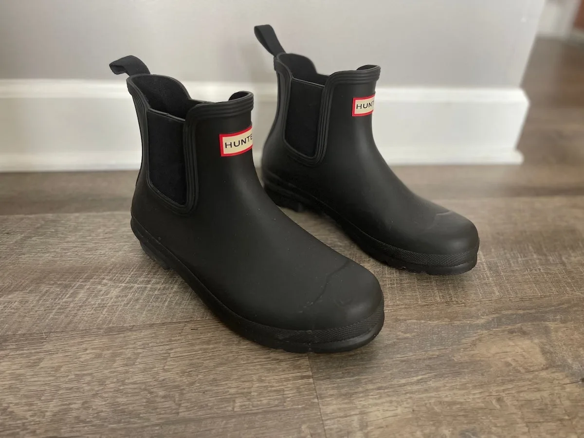 Hunter Chelsea Rain Boots sitting on wood floor