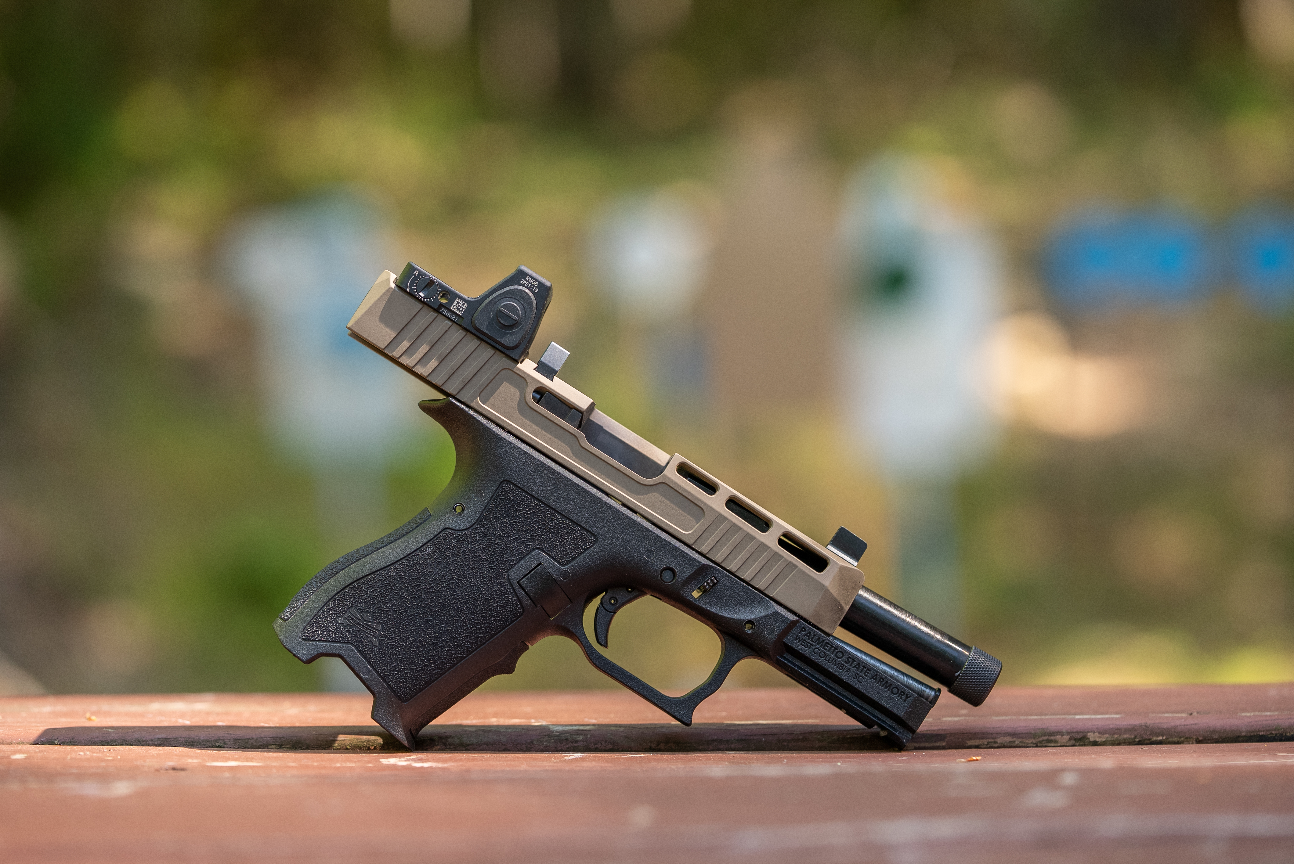 A 9mm pistol with a red-dot sight. 