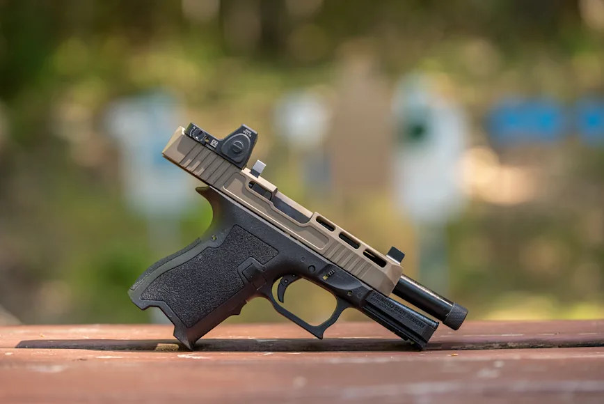 A 9mm pistol with a red-dot sight.