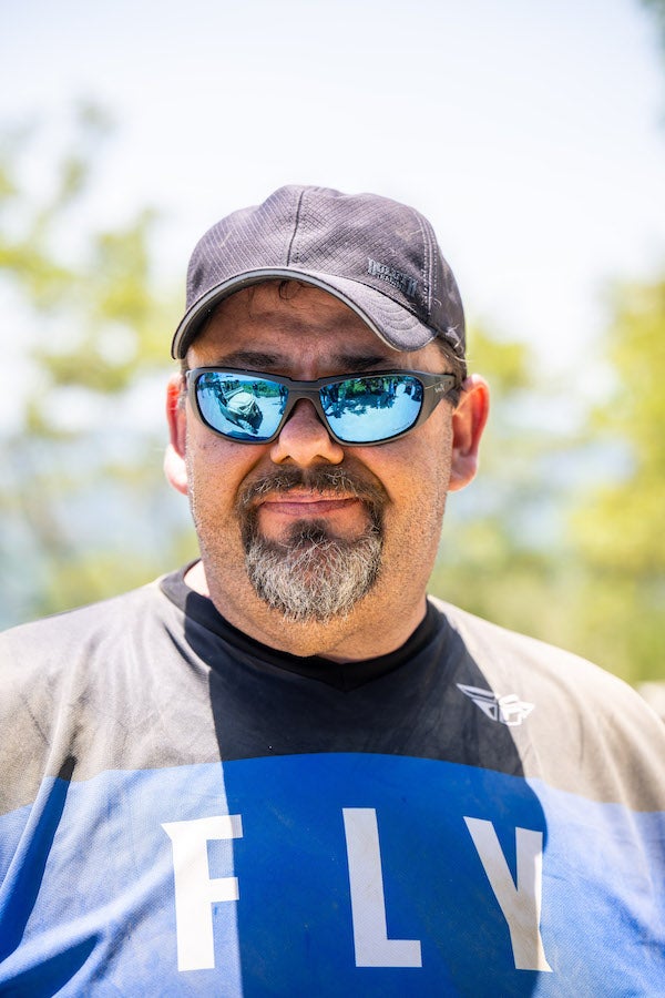Derrek Sigler wearing a blue Fly Racing jersey and a black hat