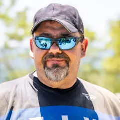 Derrek Sigler wearing a blue Fly Racing jersey and a black hat
