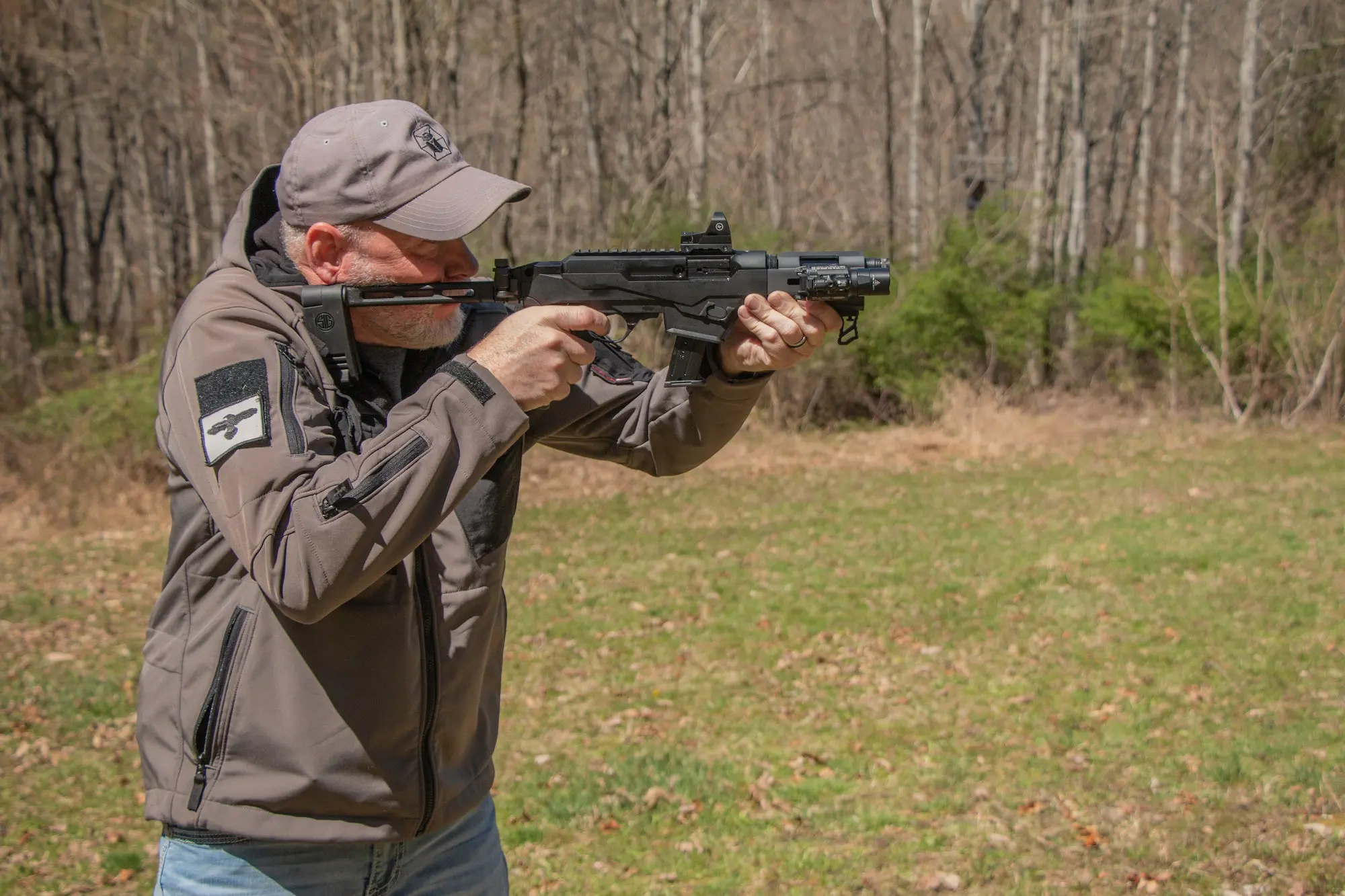 Man shooting a pistol with an arm brace.