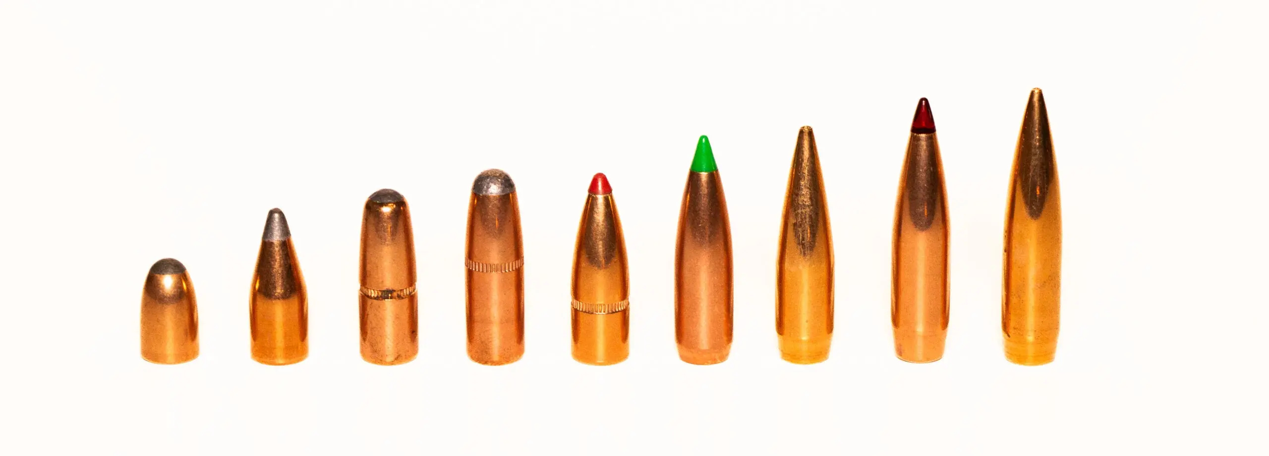 A line-up of bullets increasing from low-BC left to high-BC examples on the right.