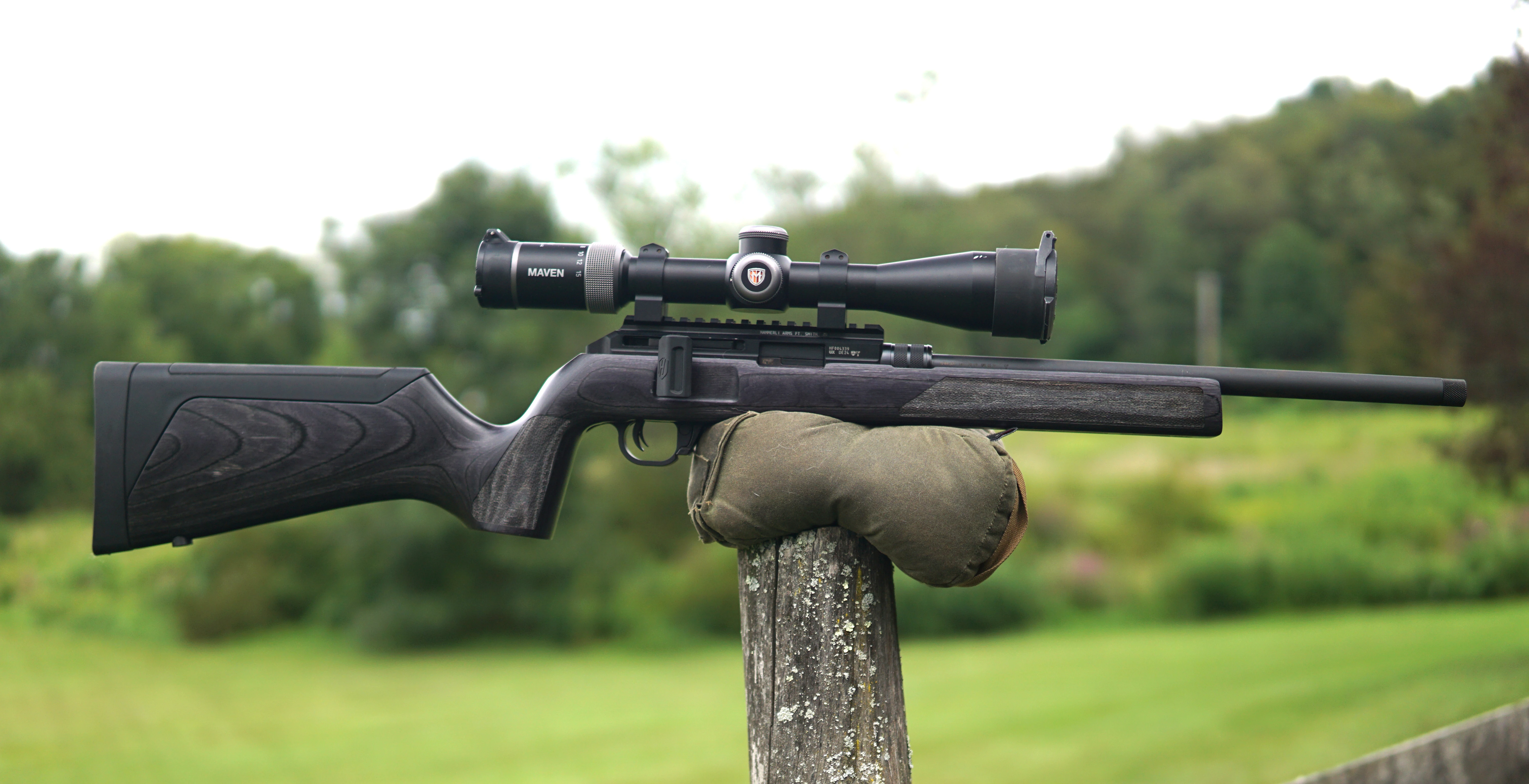 The new Hammerli Arms Force B1 22 Rifle resting on a post in a field.