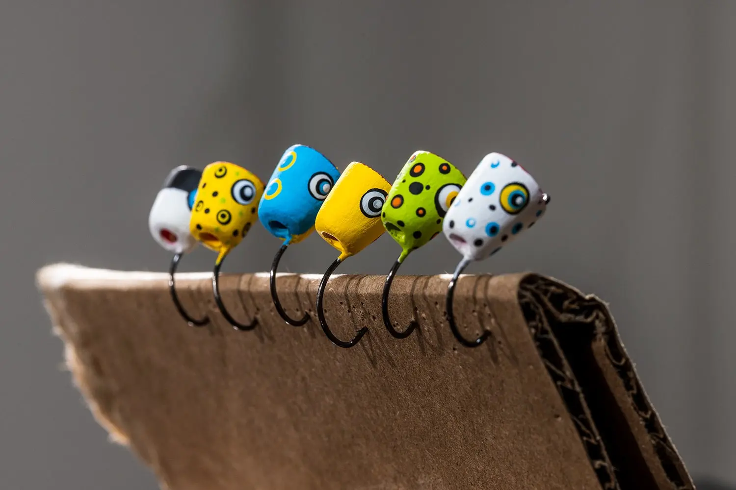 newly painted popper heads drying on a piece of cardboard