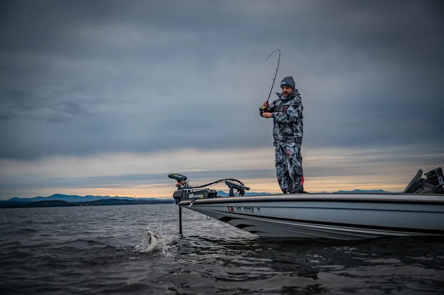 Angler fighting fish on bass boat