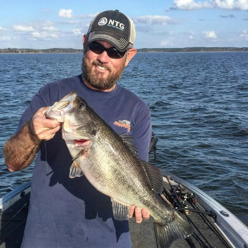 fisherman holding up a giant largemouth bass