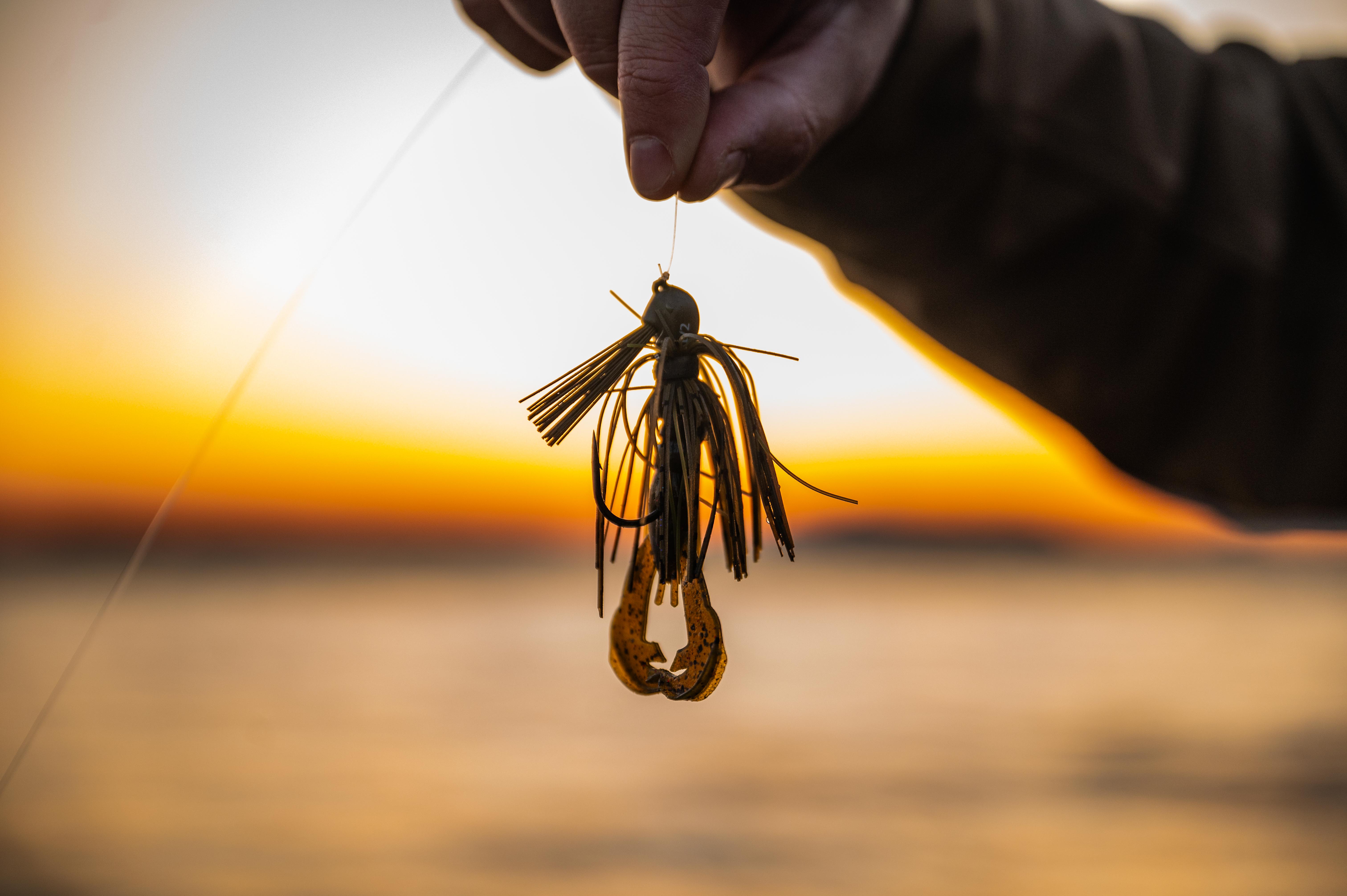 Hand holding fishing jig