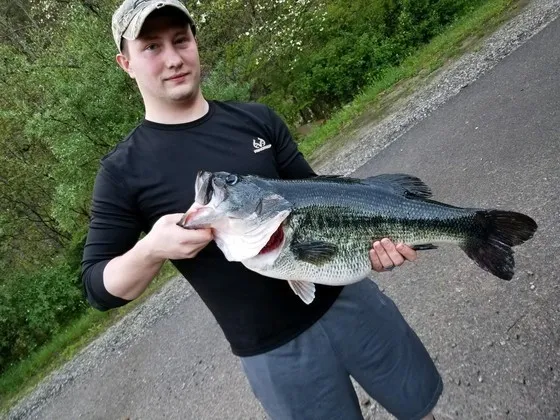 An angler poses with the Kentucky state-record largemouth bass. 