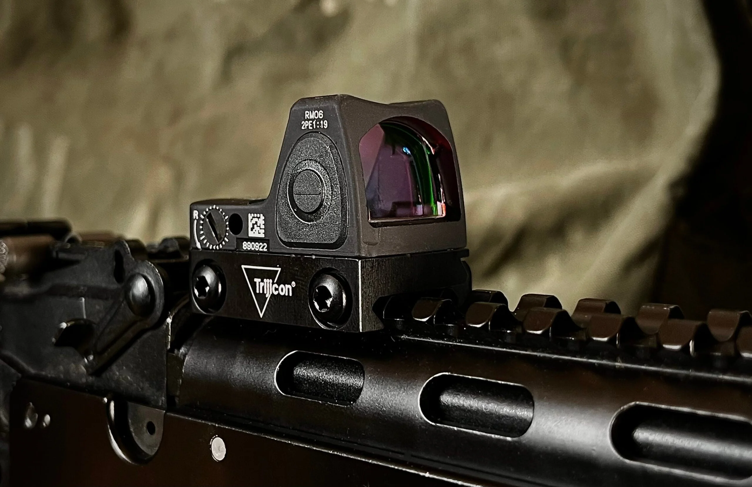 A Trijicon RMR sight mouted to a Picatinny rail on a modern sporting rifle