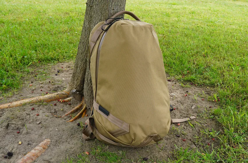 Able Carry Daily Backpack sitting on grass