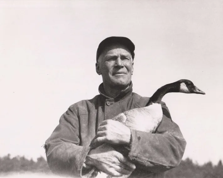 Man holding a goose