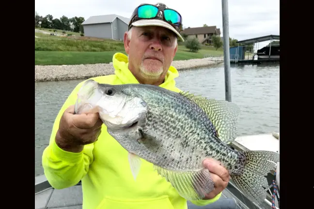 An angler poses with a potential state record crappie. 