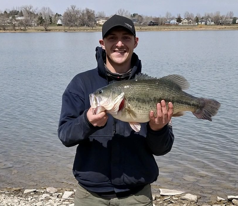 An angler poses with the Montana state record largemouth bass. 